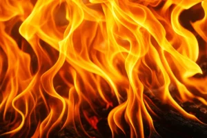 Intense close-up of swirling orange flames, illustrating the destructive power of fire and the urgent need for smoke removal and property recovery solutions.
