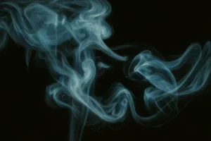 Blue smoke swirling in dark space, representing lingering airborne particles after a home fire event and the need for odor removal and ventilation